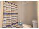 Bathroom featuring striped shower curtain with a toilet and a cute bath sign at 885 Malcom Rd, Covington, GA 30014