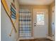 Bright bathroom showing the shower with blue striped curtain, wood-look flooring, and nautical decor at 885 Malcom Rd, Covington, GA 30014
