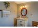 Cozy bathroom boasts vanity with granite top and oval mirror with decorative lighting at 885 Malcom Rd, Covington, GA 30014