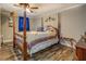 Bedroom features a canopy bed, wood-look flooring, and decorative accents at 885 Malcom Rd, Covington, GA 30014