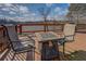 Enjoy lake views from this deck with a gas fire table and seating, creating a cozy outdoor retreat at 885 Malcom Rd, Covington, GA 30014