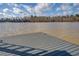Modern dock with gray composite planks extends over calm waters, with a natural shoreline in the background at 885 Malcom Rd, Covington, GA 30014