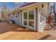 Home's exterior features gray siding, white trim, and spacious wooden deck with seating at 885 Malcom Rd, Covington, GA 30014