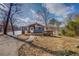Charming waterfront cottage with deck, set amidst trees and a lake view under a partly cloudy sky at 885 Malcom Rd, Covington, GA 30014