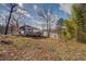 Lake house with a red roof, front wooden deck, and natural surroundings at 885 Malcom Rd, Covington, GA 30014