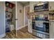 Kitchen with a well-stocked pantry featuring stainless steel appliances, and wood-look flooring at 885 Malcom Rd, Covington, GA 30014