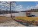 Picturesque view of the lake, a private covered boat dock, and natural landscape at 885 Malcom Rd, Covington, GA 30014