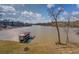 Panoramic view of the serene lake and a private covered boat dock, highlighting the waterfront property at 885 Malcom Rd, Covington, GA 30014