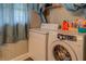 Laundry room featuring stacked washer and dryer and storage with a window at 885 Malcom Rd, Covington, GA 30014