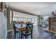 Sunlit living room features a stone fireplace, wood flooring, and open access to the dining area at 885 Malcom Rd, Covington, GA 30014