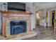 Living room featuring a stone fireplace and an open view into the kitchen at 885 Malcom Rd, Covington, GA 30014