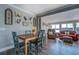 Living room showing wood flooring, and ample seating to enjoy the lake views beyond the dining table at 885 Malcom Rd, Covington, GA 30014