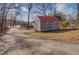 Shed with a red roof, adding charm and extra storage to the lakeside property at 885 Malcom Rd, Covington, GA 30014