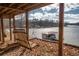 Relax on a charming porch swing overlooking the lake and a private covered boat dock at 885 Malcom Rd, Covington, GA 30014