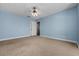 Bedroom with neutral carpet, ceiling fan, blue walls and white trim provides a comfortable living space at 1741 Canton Ln, Marietta, GA 30062