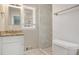 Cozy bathroom features a vanity with granite countertop, white cabinet and tiled shower at 2239 Pinewood Dr, Decatur, GA 30032