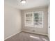 This bedroom features neutral walls, soft carpet, and a window with natural light at 2239 Pinewood Dr, Decatur, GA 30032
