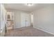 This bedroom features a bathroom, neutral walls, carpet, and a window at 2239 Pinewood Dr, Decatur, GA 30032
