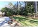This well-manicured backyard features mature trees and a lush lawn, ideal for relaxation and outdoor activities at 860 Valleymeade Se Dr, Marietta, GA 30067