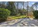 A beautiful, green backyard with lush grass, mature trees, and a concrete patio perfect for outdoor living at 860 Valleymeade Se Dr, Marietta, GA 30067