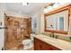 Bathroom showcasing tiled shower, granite countertop, and wood cabinets at 860 Valleymeade Se Dr, Marietta, GA 30067