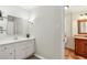 Bathroom features white vanity with granite countertop and a wall mirror at 860 Valleymeade Se Dr, Marietta, GA 30067