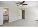 This carpeted bedroom has a ceiling fan, an ensuite, and closet doors at 860 Valleymeade Se Dr, Marietta, GA 30067