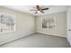 Bedroom featuring neutral walls, gray carpet, ceiling fan, and two windows at 860 Valleymeade Se Dr, Marietta, GA 30067