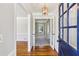 Welcoming entryway with hardwood floors, glass paneled door and decorative light fixture at 860 Valleymeade Se Dr, Marietta, GA 30067