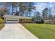 Classic home featuring an attached garage, manicured lawn and complementary landscaping at 860 Valleymeade Se Dr, Marietta, GA 30067
