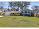 Charming blue two-story home with lush green lawn, mature trees, and attached two-car garage at 860 Valleymeade Se Dr, Marietta, GA 30067
