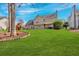 Large backyard with playset and outdoor seating area with view of the home's rear exterior at 1293 Wynford Colony Sw, Marietta, GA 30064