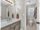 Updated bathroom with a large vanity, tile flooring and a full bath off the side at 1293 Wynford Colony Sw, Marietta, GA 30064