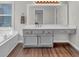 Bright bathroom with a large vanity, undermount sink, wood floors and updated mirror and light fixtures at 1293 Wynford Colony Sw, Marietta, GA 30064