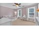 Bright bedroom with a ceiling fan, large window and neutral carpet and paint at 1293 Wynford Colony Sw, Marietta, GA 30064