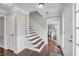 Inviting foyer with hardwood floors, white wainscoting, and staircase leading to the upper level at 1293 Wynford Colony Sw, Marietta, GA 30064