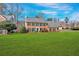 A well-maintained brick house with a spacious green lawn and mature trees, set in a residential area at 1293 Wynford Colony Sw, Marietta, GA 30064
