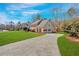 View of the house showcasing a long driveway and multi-car garage at 1293 Wynford Colony Sw, Marietta, GA 30064