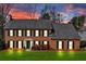 Beautiful two-story brick home with a manicured lawn and dark shutters at dusk at 1293 Wynford Colony Sw, Marietta, GA 30064