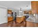 Kitchen with dark wood floors, island, stainless steel refrigerator, granite countertops, and wood cabinets at 1293 Wynford Colony Sw, Marietta, GA 30064