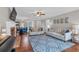 Comfortable living space featuring hardwood floors, a brick fireplace, and ample seating at 1293 Wynford Colony Sw, Marietta, GA 30064