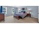 Spacious main bedroom with a tray ceiling, blue accent wall and carpeted floors at 1293 Wynford Colony Sw, Marietta, GA 30064