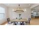 Chic dining room with a modern chandelier, wainscoting and views into the kitchen at 1533 Grayson Pkwy, Grayson, GA 30017
