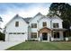 Beautiful two-story home featuring a white brick and siding exterior with a two-car garage and a covered front porch at 1533 Grayson Pkwy, Grayson, GA 30017