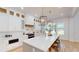 Modern kitchen with white cabinetry, quartz countertops, a large island, and stainless steel appliances at 1533 Grayson Pkwy, Grayson, GA 30017