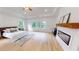 Spacious main bedroom with tray ceiling, hardwood floors, and a cozy fireplace at 1533 Grayson Pkwy, Grayson, GA 30017