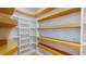 Bright pantry with custom white shelving and natural wood trim accents at 1533 Grayson Pkwy, Grayson, GA 30017