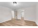 Well-lit bedroom with a light wood floor and neutral walls, showcasing the home's open floor plan at 1602 Bar J Rd, Temple, GA 30179