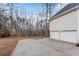 Wide driveway leads to a two-car garage with a private, wooded backyard at 1602 Bar J Rd, Temple, GA 30179