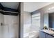 Bathroom featuring a shower, a tub, and a large, bright window at 3068 River Oak Rd, Decatur, GA 30034
